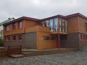 a large wooden house with a large deck at Holiday Guesthouse in Stykkishólmur