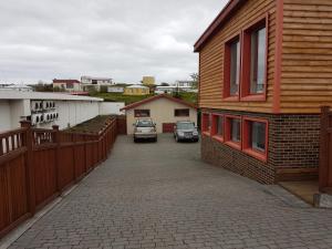a car parked in a parking lot next to a house at Holiday Guesthouse in Stykkishólmur