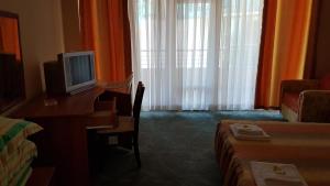 a hotel room with a desk with a computer on it at Hotel Venecia in Primorsko
