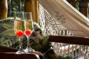 two glasses of champagne sitting on a bench at Villa dos Corais in Morro de São Paulo