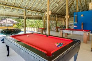 a pool table with balls on top of it in a room at Villa dos Corais in Morro de São Paulo