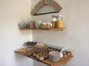 a shelf with a bunch of food on a wall at La Stregatta in Triora