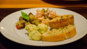 a white plate with food on a table at Villa dos Corais in Morro de São Paulo