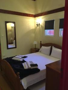 a bedroom with a bed with a mirror on it at Quinta do Rossio, Rural Tourism in Biscoitos