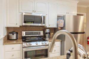 a kitchen with a stainless steel refrigerator and a microwave at Luxurious Palo Alto/Stanford-Business Ready in Palo Alto