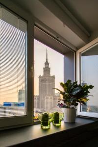 a window with a view of the empire state building at Apartament Świętokrzyska in Warsaw