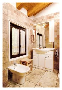 a bathroom with a sink and a toilet and a mirror at Al Gallo Nero in Borgoricco