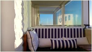 a window in a room with a couch and a pillow at Panorama Penthouse in Espinho