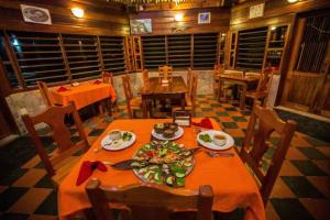 uma sala de jantar com mesas e cadeiras e uma mesa com comida em Costa De Cocos em Xcalak