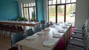 a row of tables and chairs in a room at Kõrveküla Holiday Centre in Kõrveküla