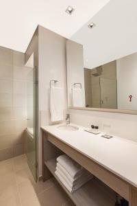 a bathroom with a sink and a mirror at Hotel Sites Montería in Montería