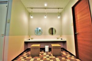 a bathroom with a sink and two stools at My Place in Naha