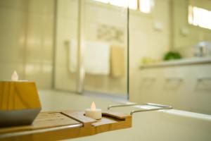 a candle sitting on top of a wooden table at Bidgee Motor Inn in Hay