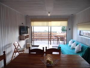 a living room with a couch and a table at Cabañas Urmeneta Sur in Tongoy