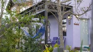 a door to a building with chairs and a tree at La Mamunia in Las Gaviotas