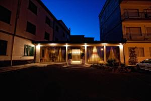 a house with lights on the front of it at night at Hotel Villa Sturzo in Caltagirone