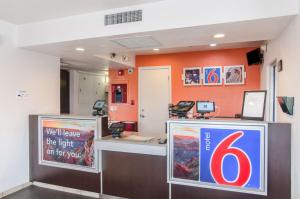 a counter with a lot of signs on it at Motel 6-Rock Springs, WY in Rock Springs