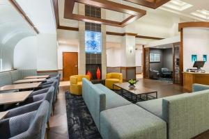 a lobby of a hotel with couches and tables at Hyatt Place Rogers/Bentonville in Rogers