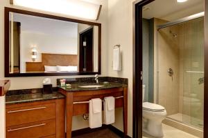 a bathroom with a sink and a toilet and a mirror at Hyatt Place Savannah Airport in Savannah