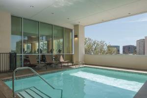 a swimming pool with a view of a building at Hyatt Place Houston Galleria in Houston