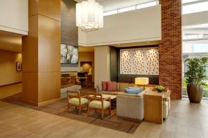 a lobby with a couch and a table and chairs at Hyatt Place New York Yonkers in Yonkers
