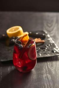 a red drink with orange slices on a table at Hyatt Place West Des Moines/Jordan Creek in West Des Moines