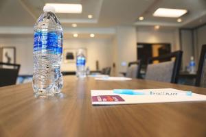 a bottle of water sitting on top of a table at Hyatt Place Austin Airport in Austin