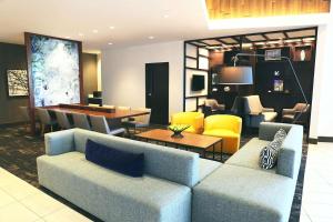 a living room with two couches and a dining room at Hyatt Place Austin Airport in Austin