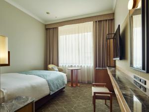 a hotel room with a bed and a television at Hotel The Celestine Tokyo Shiba in Tokyo