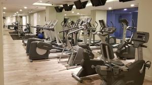a gym with rows of treadms and cardio machines at Meliá Kuala Lumpur in Kuala Lumpur