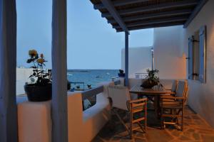 a balcony with a table and chairs and the ocean at Evita Apartments in Aliki