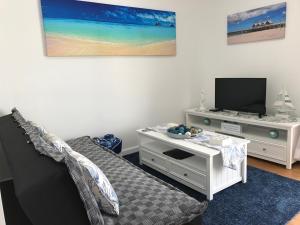 a living room with a couch and a tv at Marina View Chalets in Wannanup
