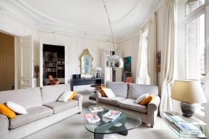 a living room with two couches and a table at Haussmann 168 in Paris
