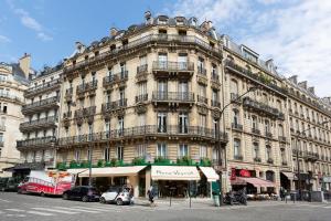 a large building on the corner of a city street at Haussmann 168 in Paris