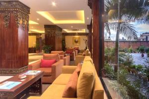 a hotel lobby with a couch and a table at Hotel Tibet International in Kathmandu