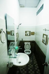 a bathroom with a sink and a toilet at Gia Pham Hotel in Da Lat