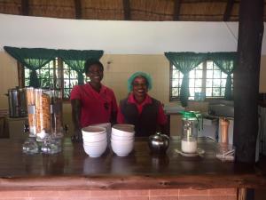 two people standing at a counter in a kitchen at Villa Grande Lodge in Louis Trichardt +147 photos