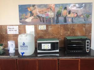 a counter with a toaster and a toaster and a microwave at Villa Grande Lodge in Louis Trichardt
