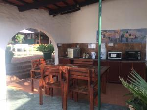 an outdoor kitchen with a wooden table and chairs at Villa Grande Lodge in Louis Trichardt