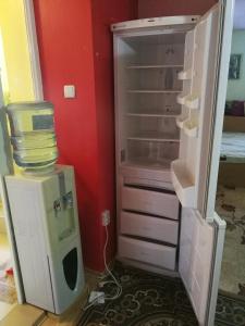 an empty refrigerator and a computer in a room at Two Bedroom Townhouse Mika in Ruse