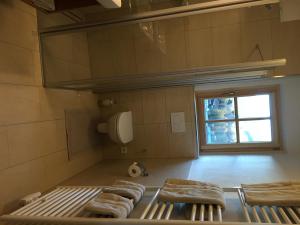 a kitchen with four chairs and a window at The Bear's Lair in Saalbach Hinterglemm