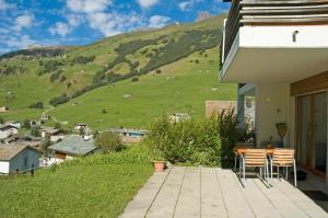 a house with a patio with a view of a mountain at Ferienwohnung Mura in Vals