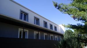 a white building with windows on the side of it at Dom Sportowca in Racibórz