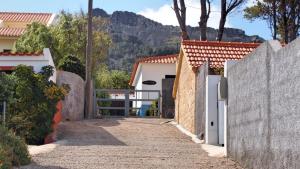 a pathway leading to a house with a fence at OurMadeira - Villa Mary, informal, close to the beach in Porto Santo