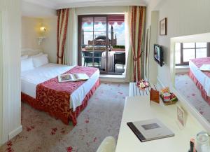 a hotel room with two beds and a television at The And Hotel Sultanahmet- Special Category in Istanbul