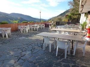 a group of tables and chairs on a patio at Letea in Régil