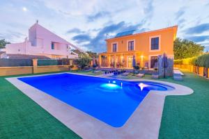 a house with a swimming pool in front of a house at Finca Ca Nantonia in Sa Coma