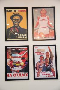 a group of posters on a wall at Art Studio in Tashkent