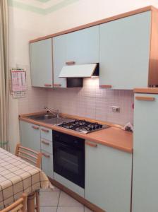 a kitchen with a sink and a stove top oven at La Casa di Rosa by PortofinoVacanze in Santa Margherita Ligure