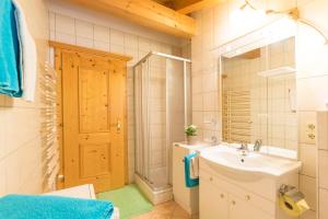 łazienka z umywalką, toaletą i lustrem w obiekcie Appartement Alpina w Alpbach +37 zdjęć